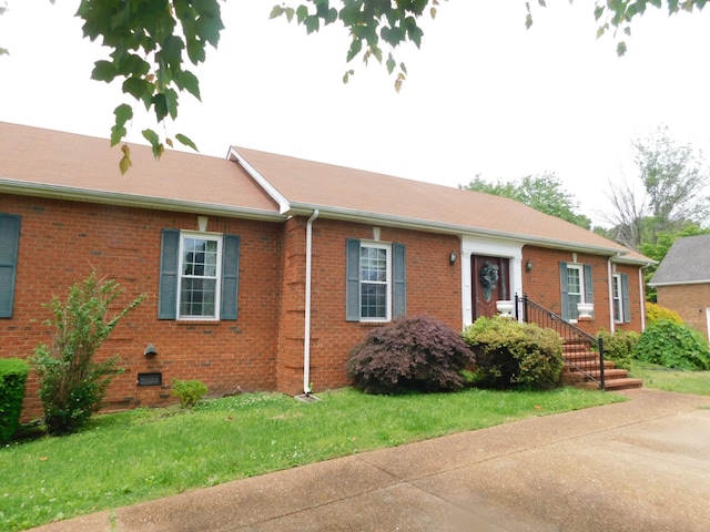 1129 Adam Dr, Cottontown, TN 37048 - ranch-style home featuring brick siding and a front lawn