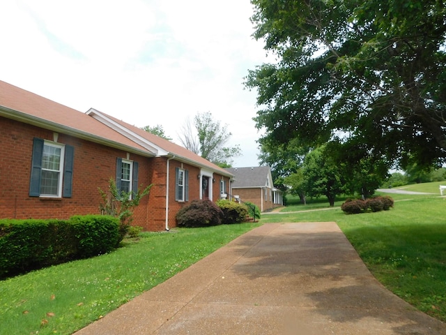 1129 Adam Dr, Cottontown, TN 37048 - view of side of home with brick siding and a lawn