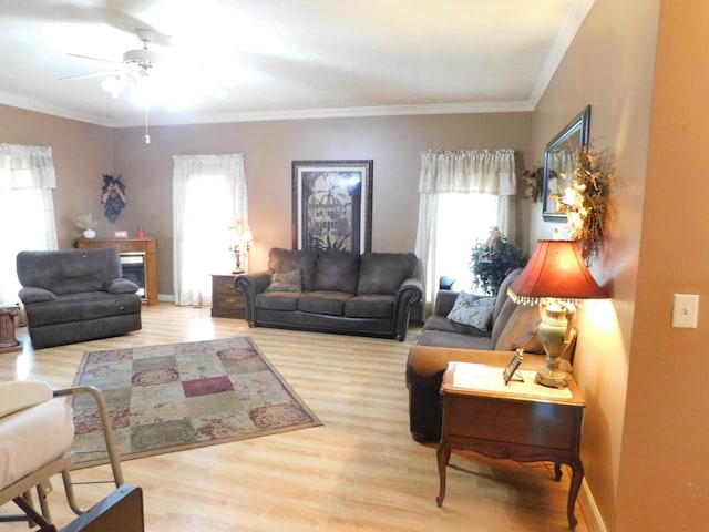 1129 Adam Dr, Cottontown, TN 37048 - living room featuring healthy amount of natural light, wood finished floors, a ceiling fan, and ornamental molding