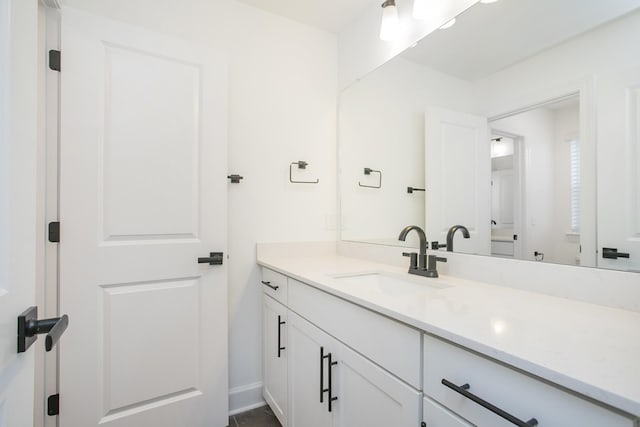 bathroom with vanity and baseboards