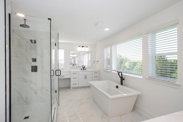 full bathroom with marble finish floors, a marble finish shower, vanity, a freestanding bath, and baseboards