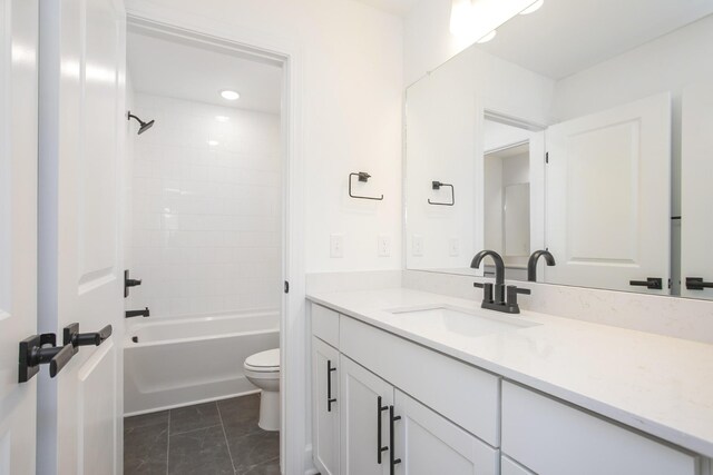 bathroom with toilet, vanity, and  shower combination