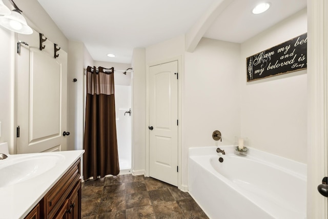 bathroom featuring a garden tub, a shower with curtain, vanity, stone finish flooring, and recessed lighting