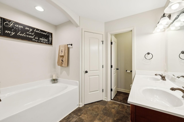 bathroom featuring a bath, double vanity, and stone finish floors