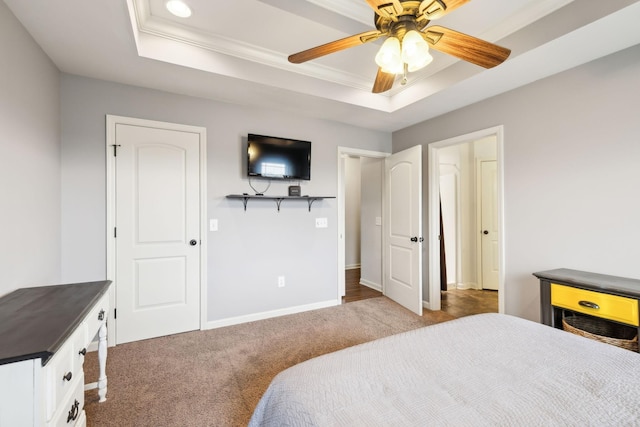 bedroom with a raised ceiling, carpet flooring, ornamental molding, and baseboards