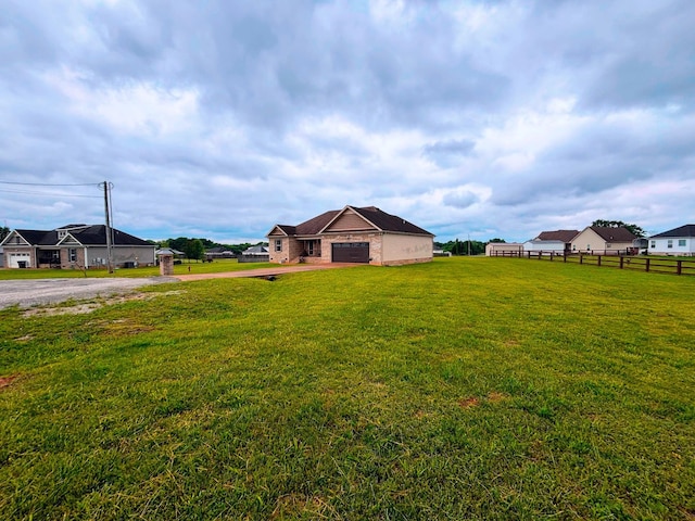 view of yard with driveway and a garage