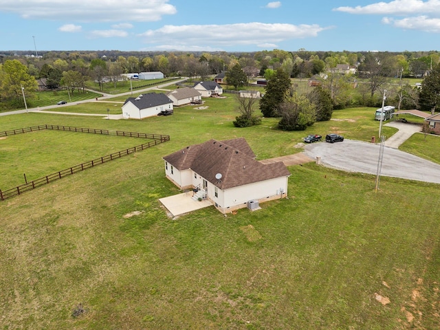 aerial view of property and surrounding area with a tree filled landscape