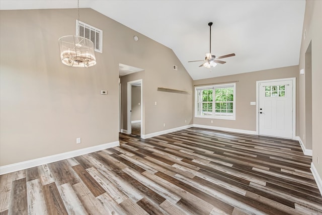 unfurnished living room featuring a ceiling fan, wood finished floors, high vaulted ceiling, a chandelier, and baseboards