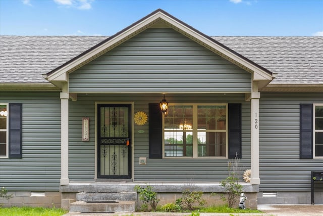 view of front of house with crawl space, a shingled roof, and covered porch