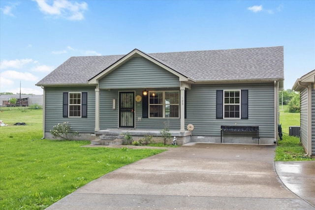 view of front of property with covered porch, central AC, a front lawn, and roof with shingles