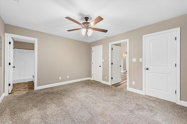 unfurnished bedroom featuring carpet, baseboards, connected bathroom, and a ceiling fan