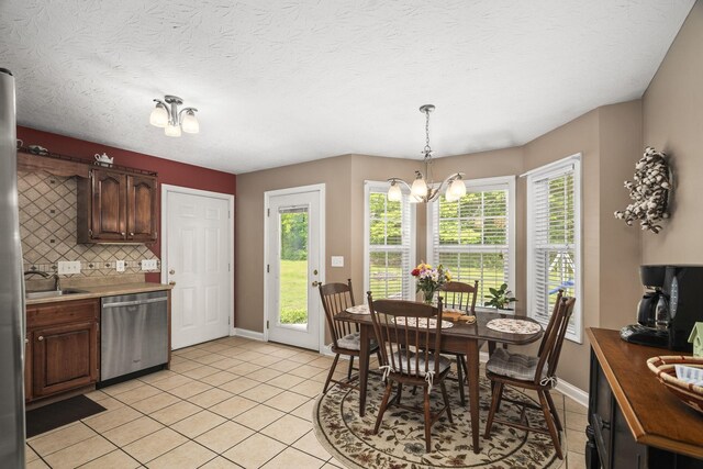 103 Nashay Ct, Portland, TN 37148 - kitchen with dishwasher, light tile patterned floors, baseboards, backsplash, and light countertops
