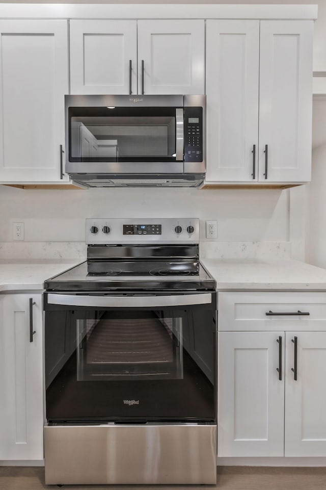 kitchen with appliances with stainless steel finishes and white cabinetry
