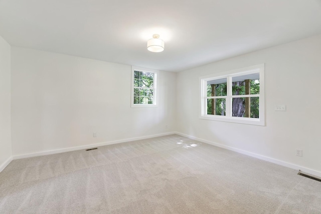 carpeted empty room with baseboards