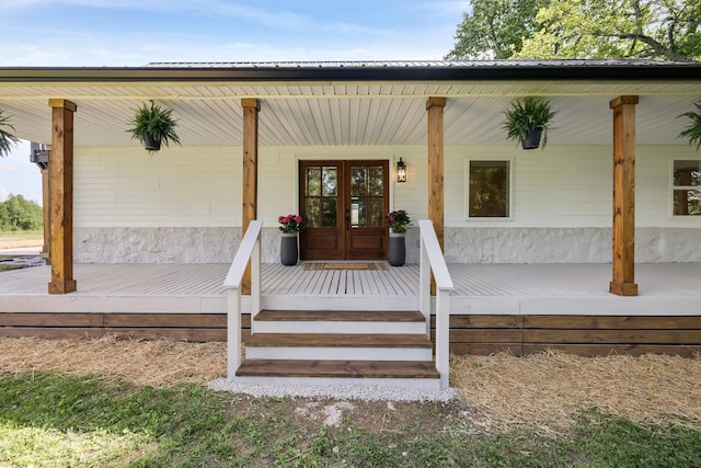 doorway to property featuring a porch and french doors