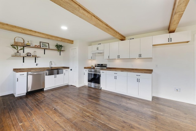 kitchen with stainless steel appliances, butcher block countertops, beamed ceiling, a sink, and open shelves
