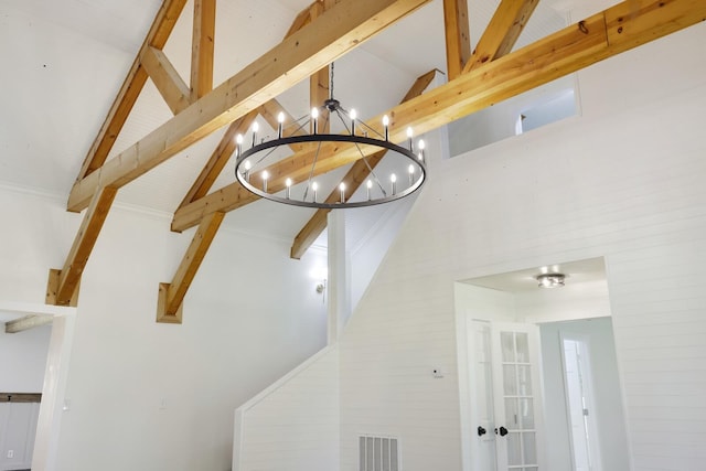detailed view of beam ceiling and a chandelier