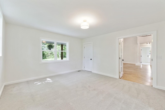 empty room featuring carpet flooring and baseboards
