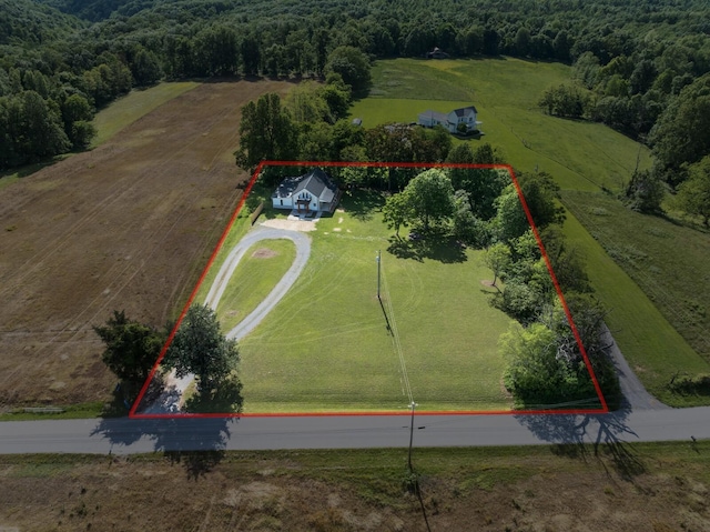 aerial view of sparsely populated area with property boundaries highlighted and a heavily wooded area