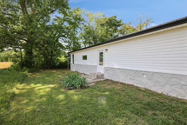 view of property exterior featuring a lawn