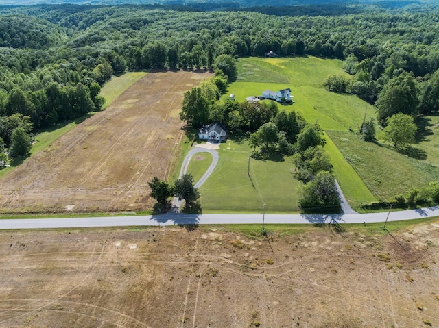 aerial view of sparsely populated area featuring a heavily wooded area