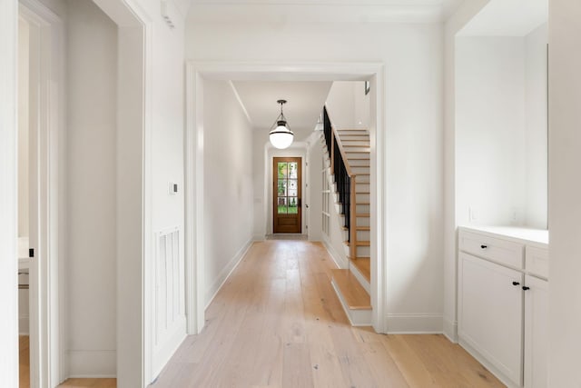 entrance foyer with light wood-style floors and baseboards