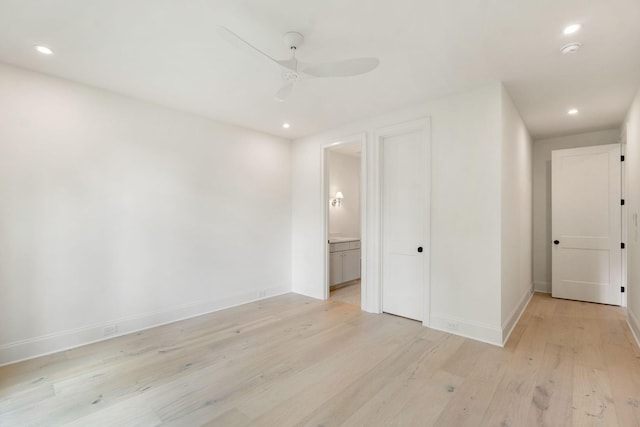 unfurnished bedroom with light wood-style floors, recessed lighting, baseboards, ensuite bath, and a ceiling fan