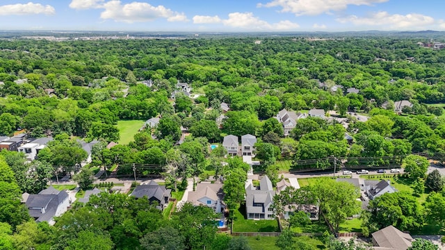aerial perspective of suburban area featuring a heavily wooded area