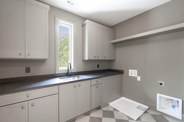 washroom with hookup for an electric dryer, cabinet space, and washer hookup