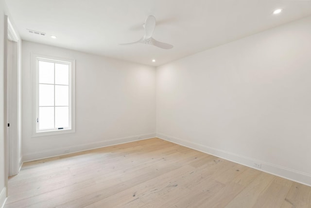 empty room with baseboards, light wood-style flooring, a ceiling fan, and recessed lighting