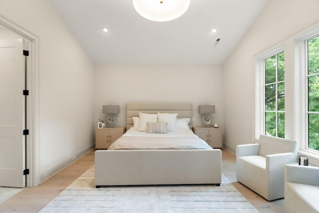 bedroom featuring multiple windows, light wood finished floors, lofted ceiling, recessed lighting, and baseboards