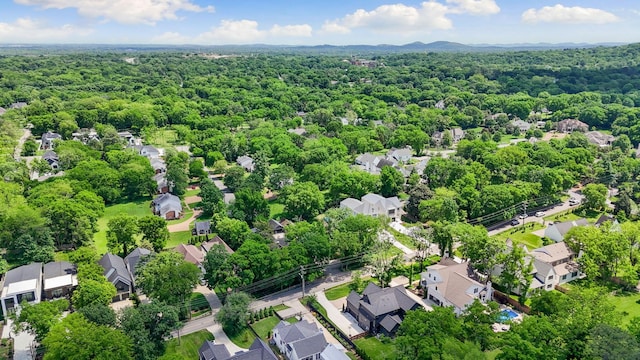 aerial view of residential area featuring a heavily wooded area