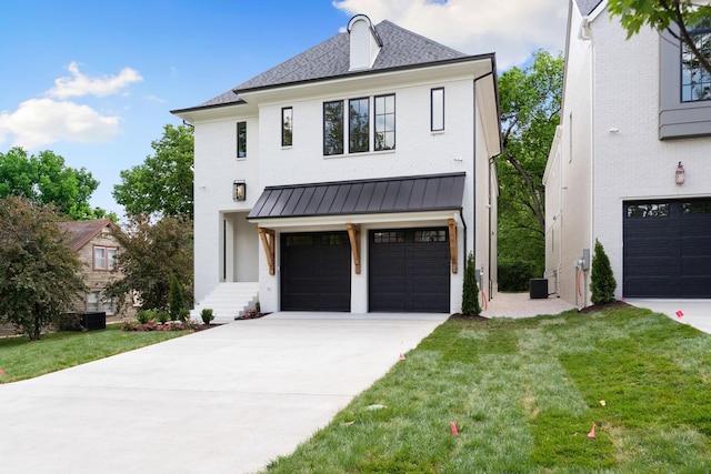 view of front facade featuring an attached garage, concrete driveway, brick siding, and a front lawn