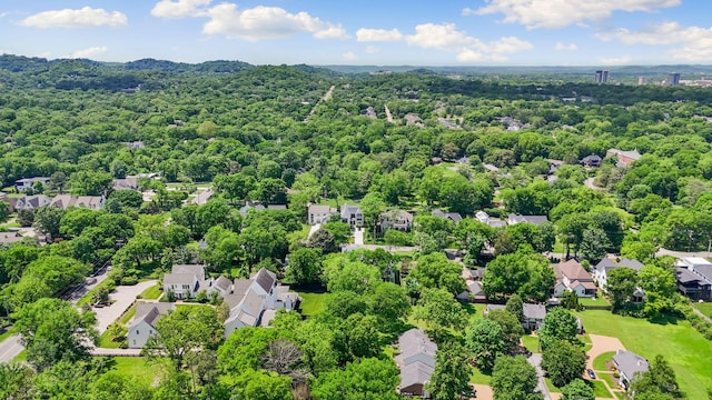 aerial view of residential area featuring a heavily wooded area