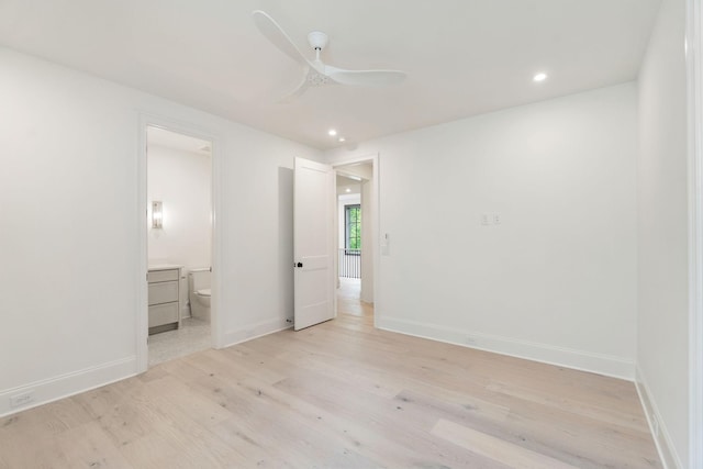 unfurnished bedroom with light wood-style flooring, recessed lighting, baseboards, connected bathroom, and ceiling fan