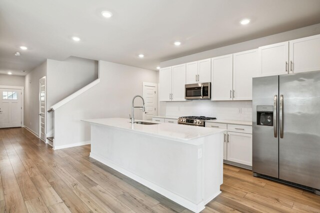 440 Golden Meadow Ln, Hendersonville, TN 37075 - kitchen featuring stainless steel appliances, a sink, a kitchen island with sink, white cabinetry, and light countertops