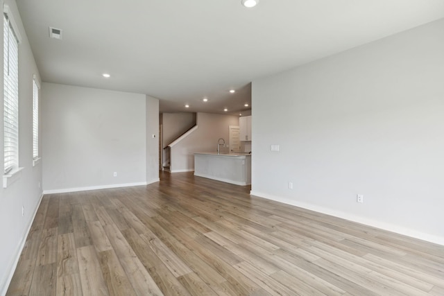 440 Golden Meadow Ln, Hendersonville, TN 37075 - unfurnished living room featuring recessed lighting, light wood-style floors, baseboards, a sink, and stairway