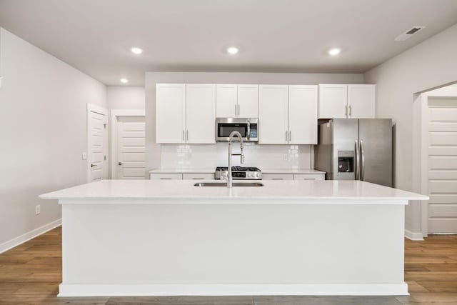 440 Golden Meadow Ln, Hendersonville, TN 37075 - kitchen with appliances with stainless steel finishes, a center island with sink, baseboards, light countertops, and white cabinetry