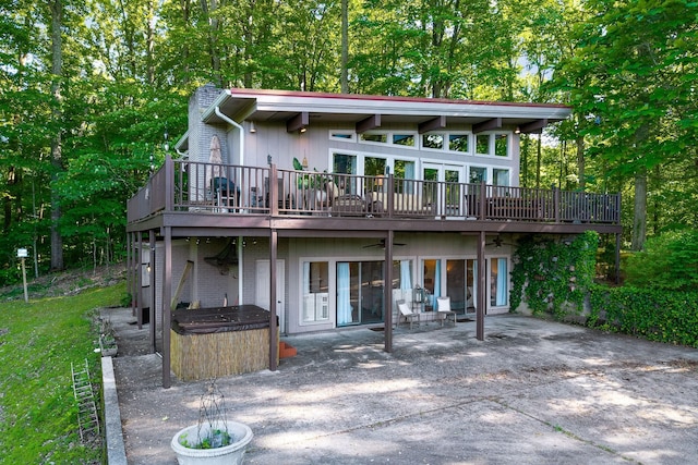 698 Crestview Dr, Sparta, TN 38583 - rear view of property featuring a hot tub, a patio, a chimney, a ceiling fan, and a deck