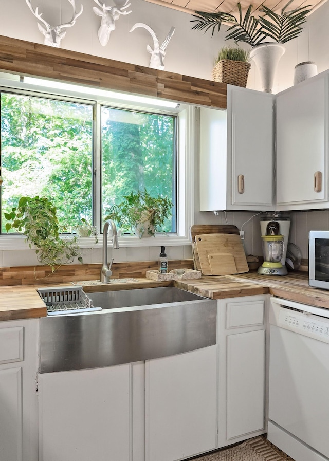 698 Crestview Dr, Sparta, TN 38583 - kitchen with white dishwasher, butcher block countertops, white cabinets, and a sink