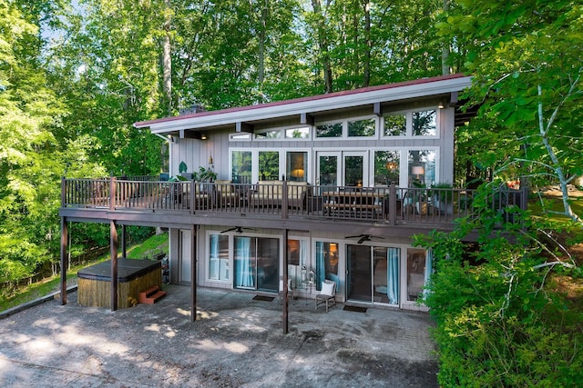 698 Crestview Dr, Sparta, TN 38583 - back of property with a hot tub, a patio, a ceiling fan, board and batten siding, and a wooden deck