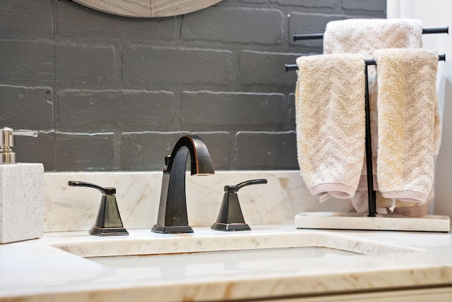 bathroom view of a sink and tasteful backsplash