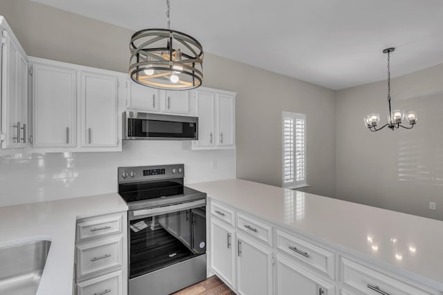 2732 Linmar Ave, Nashville, TN 37215 - kitchen featuring stainless steel appliances, a chandelier, light countertops, white cabinets, and tasteful backsplash