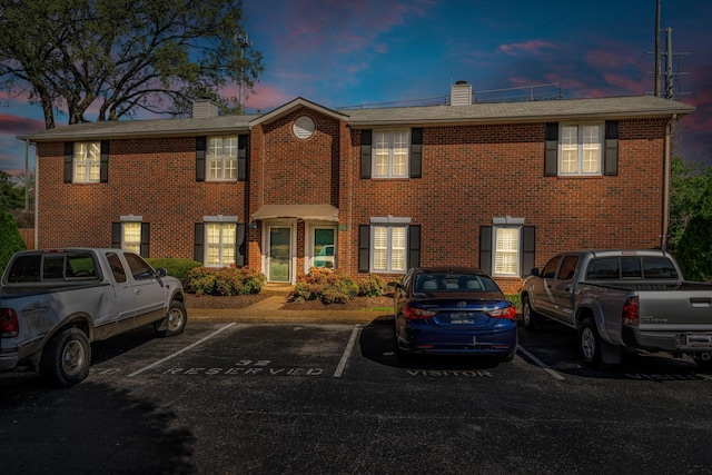 2732 Linmar Ave, Nashville, TN 37215 - view of property featuring a chimney, brick siding, and uncovered parking