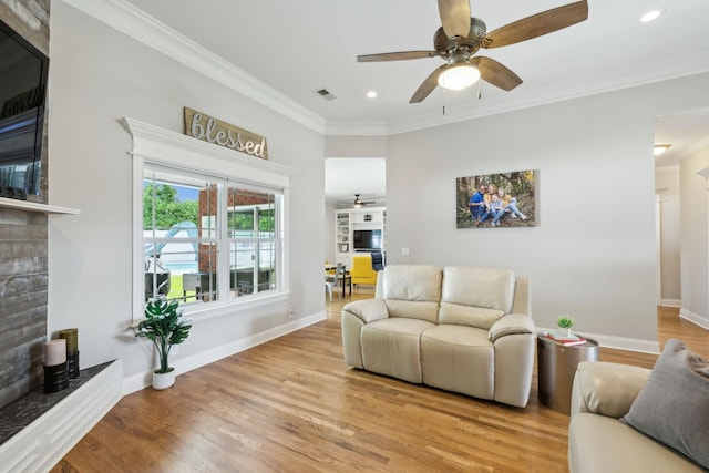 905 W Sagefield Dr, Smyrna, TN 37167 - living area with ceiling fan, ornamental molding, a fireplace with raised hearth, light wood-type flooring, and recessed lighting
