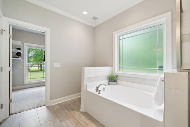905 W Sagefield Dr, Smyrna, TN 37167 - bathroom with ornamental molding, a garden tub, baseboards, wood finished floors, and recessed lighting