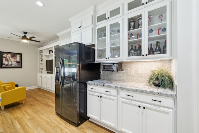 905 W Sagefield Dr, Smyrna, TN 37167 - kitchen with black fridge with ice dispenser, backsplash, white cabinetry, a ceiling fan, and baseboards