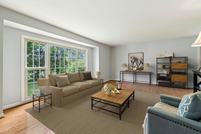 living area with wood finished floors and baseboards