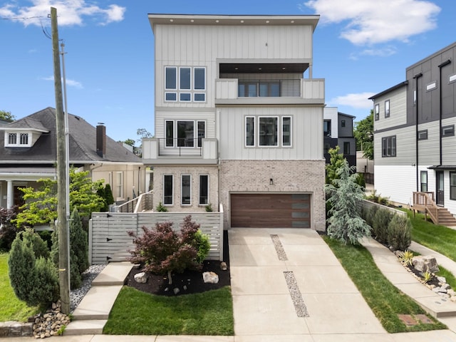 1211A Sigler St, Nashville, TN 37203 - contemporary home with brick siding, driveway, a balcony, a garage, and fence