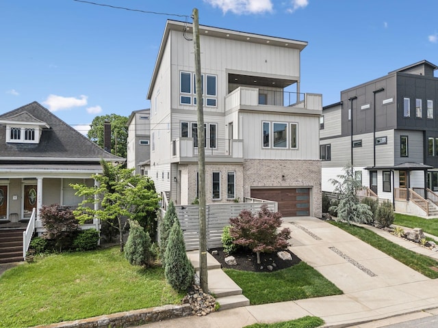 1211A Sigler St, Nashville, TN 37203 - view of front of house with a balcony, driveway, board and batten siding, and a garage